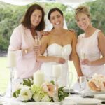Bride celebrating with mother and grandmother during elegant wedding reception