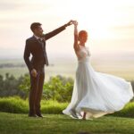 Bride and groom sharing a romantic sunset dance during their wedding day, capturing an emotional moment and unforgettable memory.