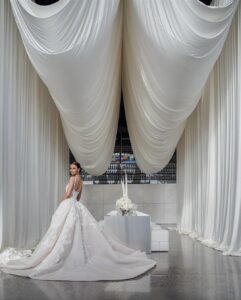 Elegant luxury wedding design featuring soft Cloud Dancer neutral tones, flowing ivory drapery, and a modern bridal aesthetic.