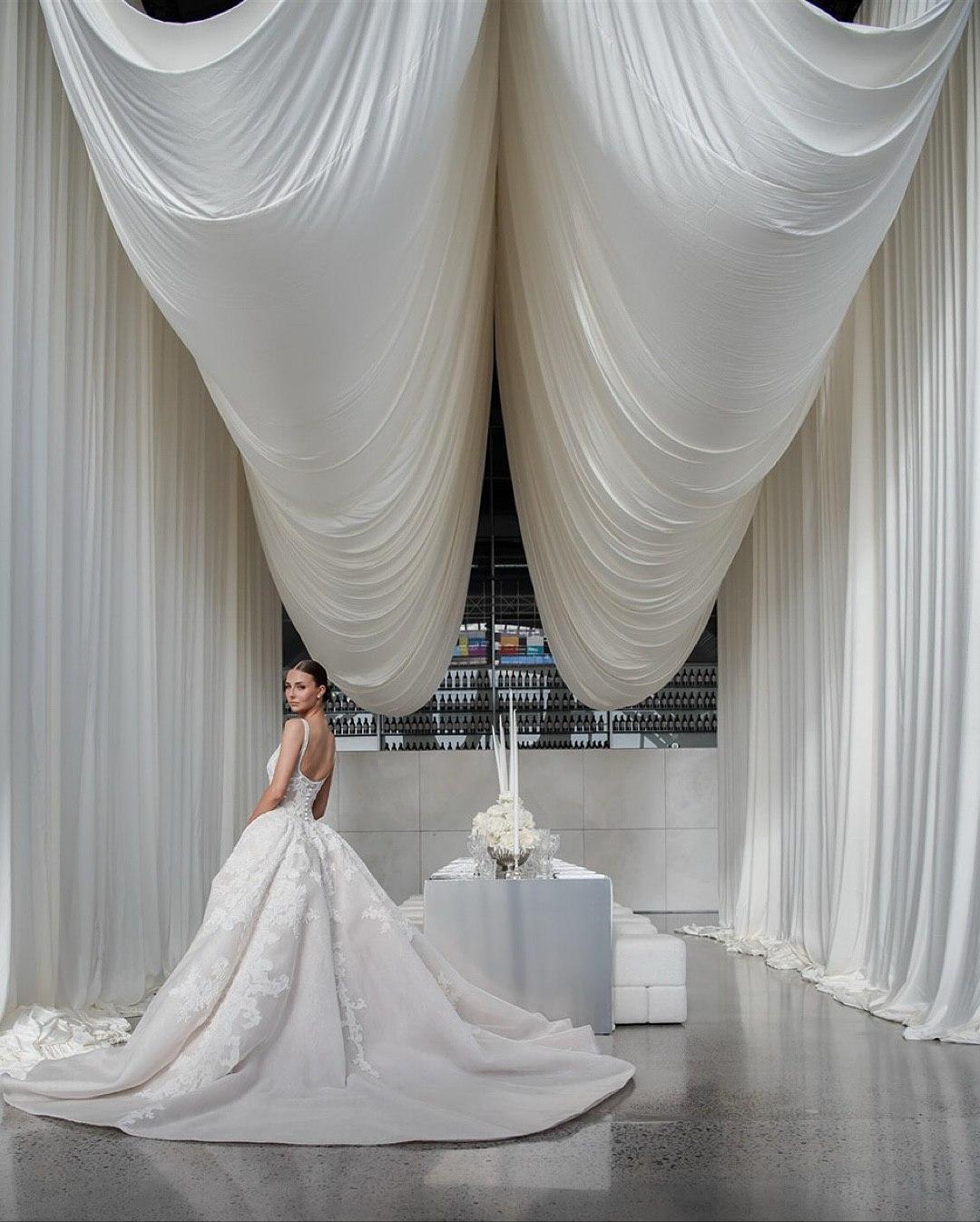 Elegant luxury wedding design featuring soft Cloud Dancer neutral tones, flowing ivory drapery, and a modern bridal aesthetic.