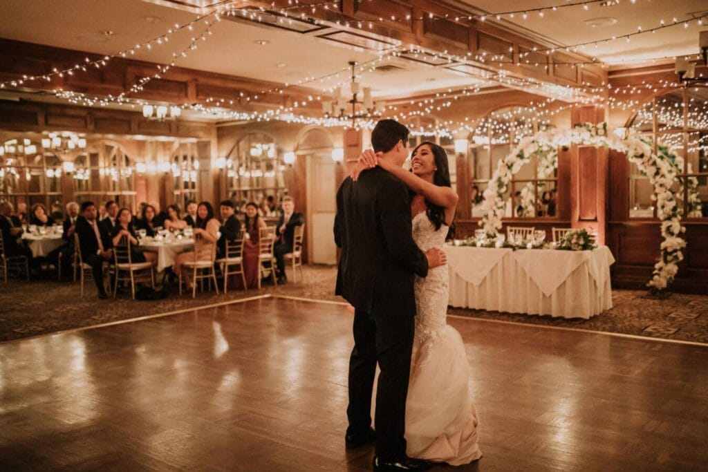 Bride and groom sharing their first dance during a romantic candlelit wedding reception at Pillar and Post in Niagara-on-the-Lake
