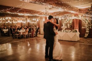 Bride and groom sharing their first dance during a romantic candlelit wedding reception at Pillar and Post in Niagara-on-the-Lake