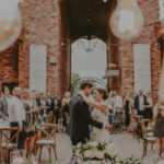 Bride and groom sharing an emotional wedding moment surrounded by guests at The Hare Wine Co. in Niagara-on-the-Lake
