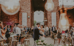 Bride and groom sharing an emotional wedding moment surrounded by guests at The Hare Wine Co. in Niagara-on-the-Lake