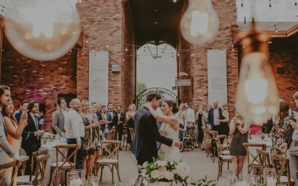 Bride and groom sharing an emotional wedding moment surrounded by guests at The Hare Wine Co. in Niagara-on-the-Lake