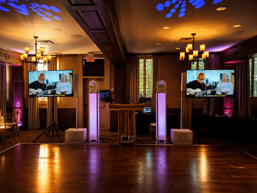 Luxury wedding DJ setup at Pillar and Post Hotel featuring professional lighting, TV displays, and upscale reception production