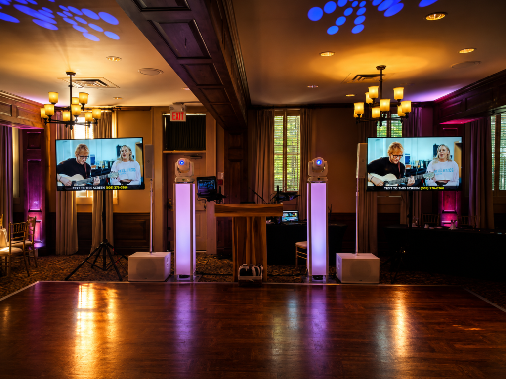 Luxury wedding DJ setup at Pillar and Post Hotel featuring professional lighting, TV displays, and upscale reception production