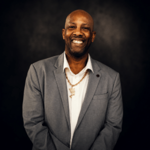 Professional portrait of DJ Francis January from Icon Events with cinematic studio lighting and dark luxury background.