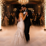 Bride and groom sharing their first dance surrounded by cold sparks and dancing on clouds during an elegant luxury wedding reception