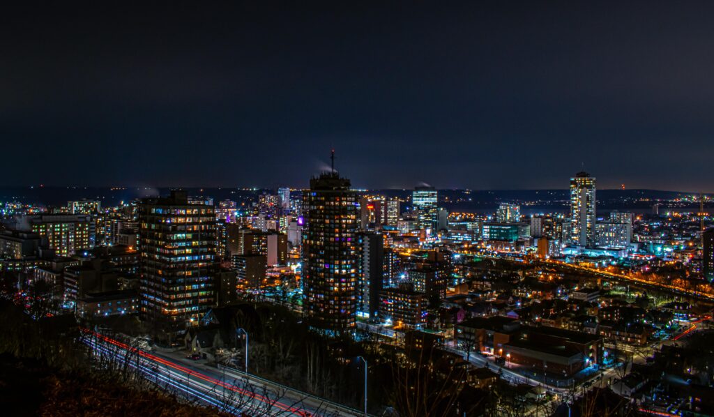 Night view of the Hamilton Ontario skyline showcasing the city lights and downtown core from the escarpment overlooking the Greater Hamilton area.