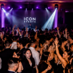 Guests celebrating on a packed dance floor with high-energy lighting and DJ entertainment at a luxury Hamilton wedding reception.