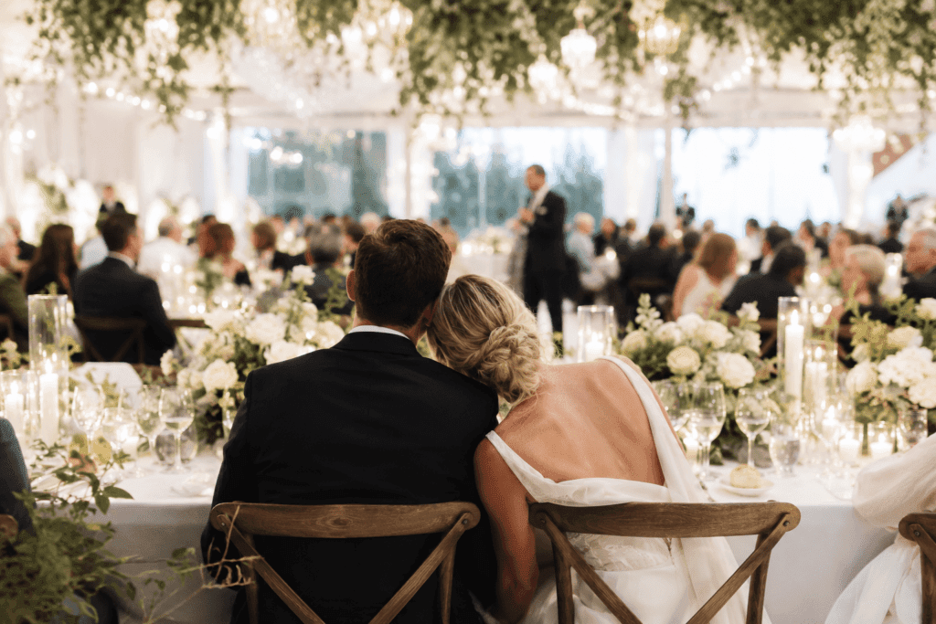 Bride and groom sharing an intimate moment during an elegant wedding reception with immersive atmosphere and candlelit décor