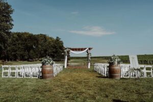 Elegant outdoor wedding ceremony at Kurtz Orchards in Niagara-on-the-Lake with romantic live music atmosphere and vineyard-inspired setting