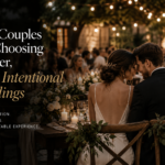 Bride and groom sharing an intimate moment at a candlelit Niagara-on-the-Lake wedding reception with guests gathered around them.