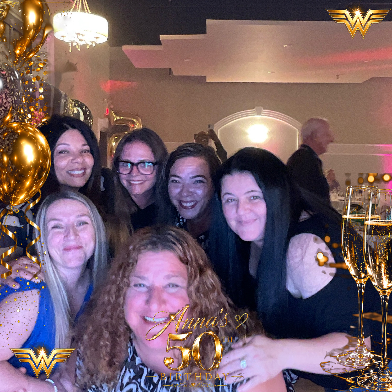 Guests posing together in a personalized 50th birthday photo booth image