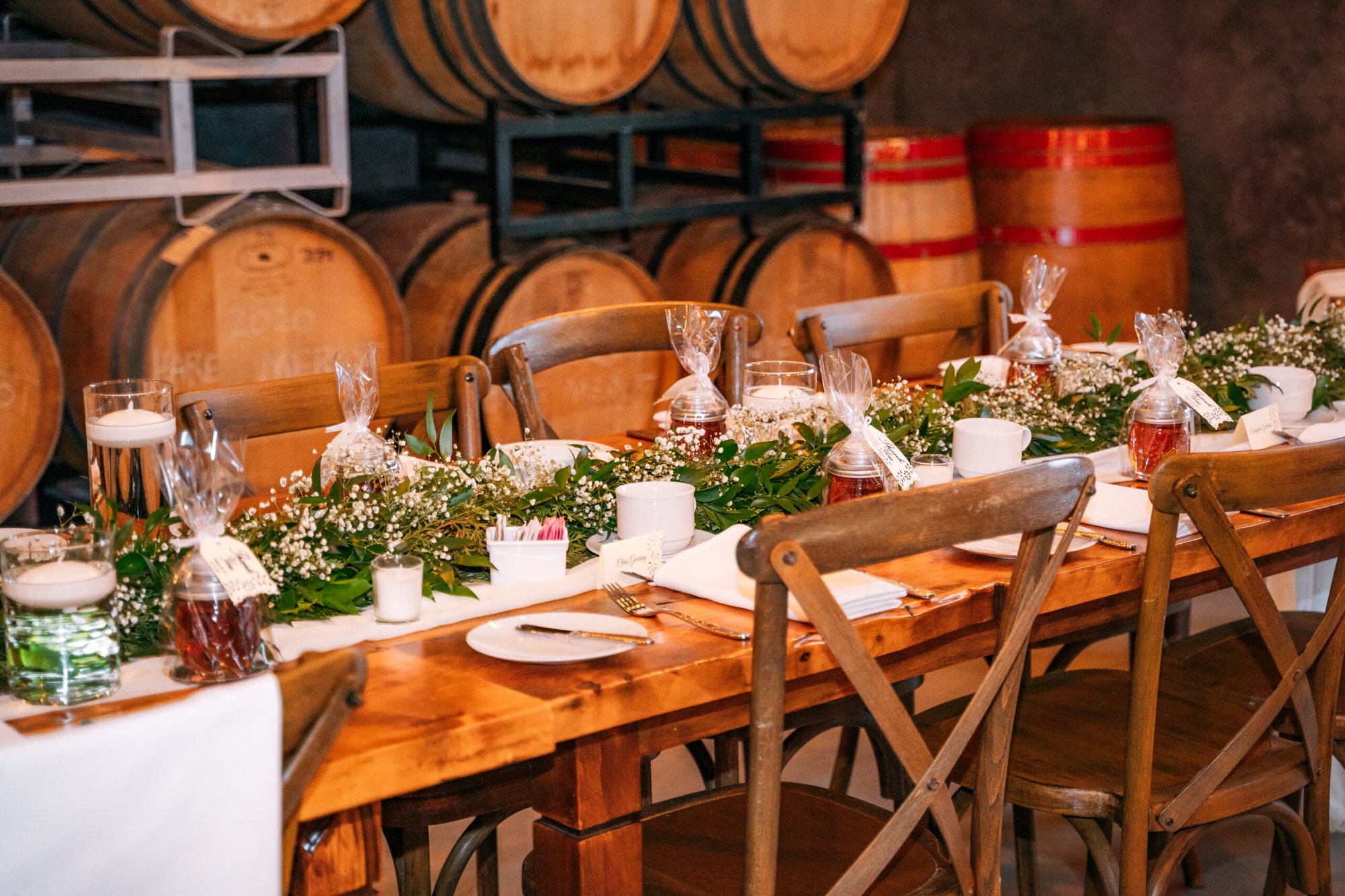 Table set among the wine barrels at The Hare Wine Co