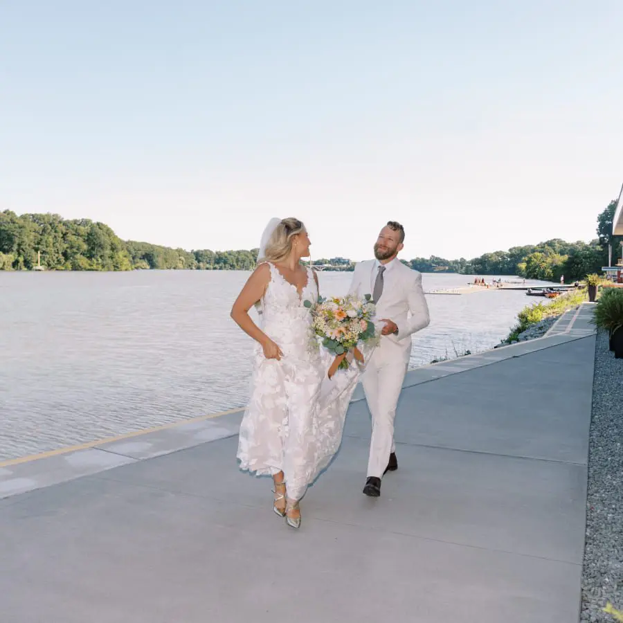Wedding couple by the water at Neil Campbell Rowing Centre