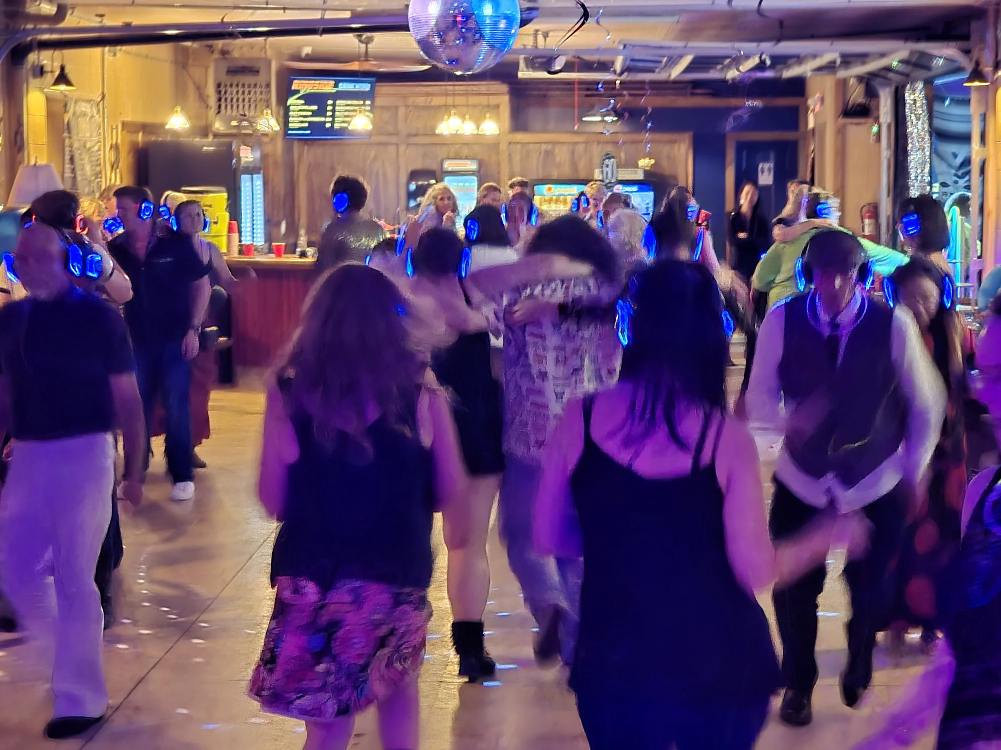 Guests enjoying multiple music channels at a silent party