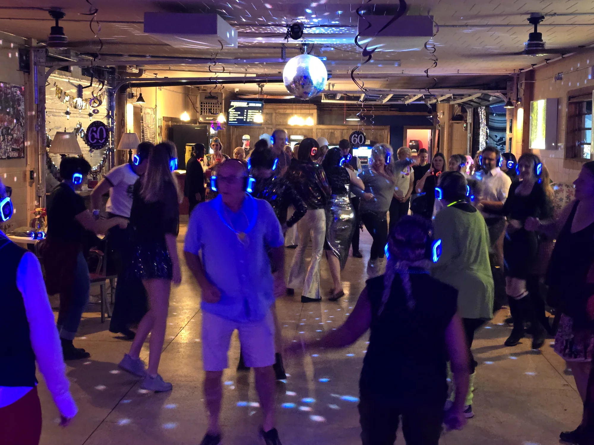 Guests dancing with glowing headphones at an Icon Events silent party