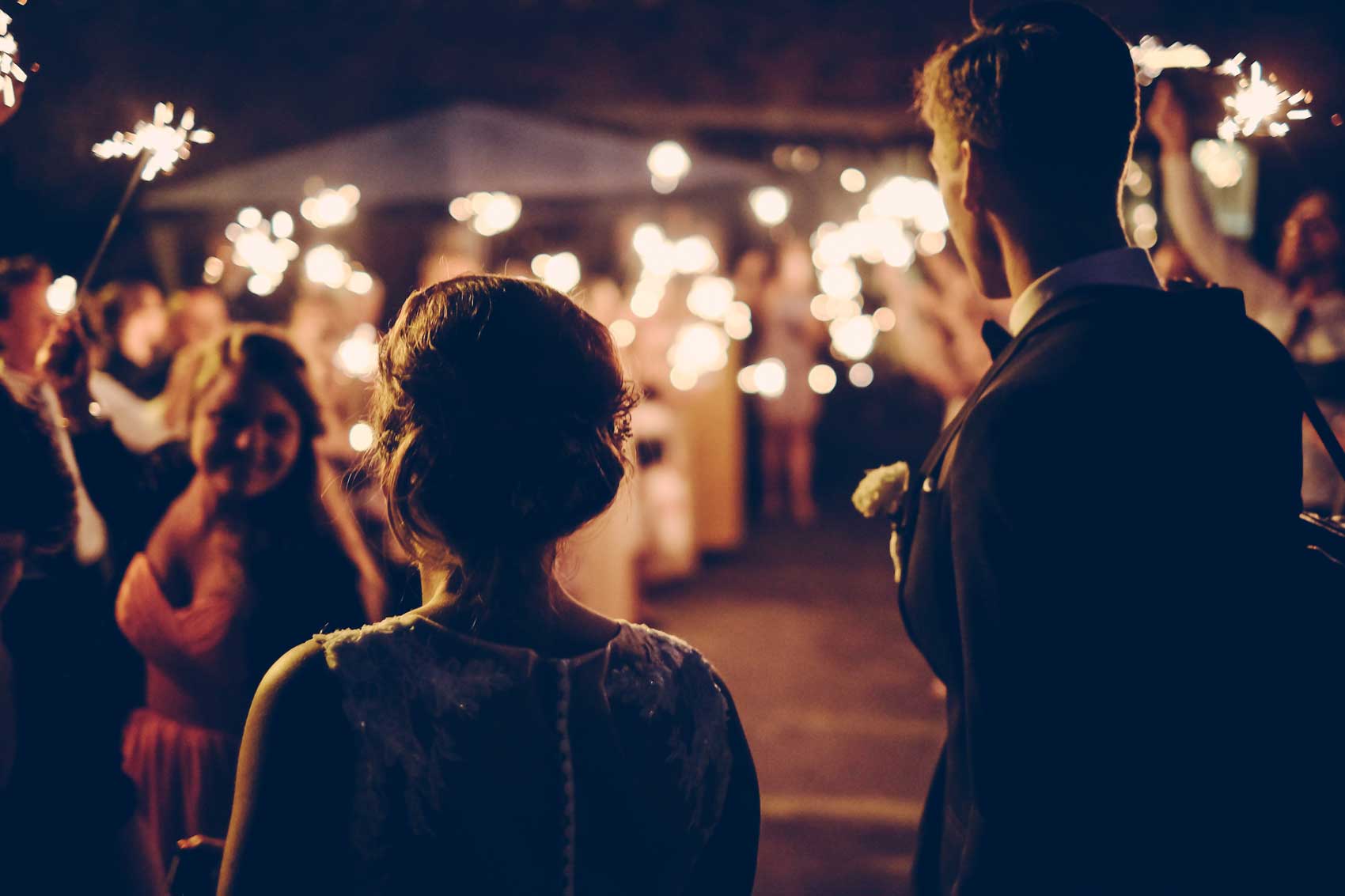 Newlyweds celebrating beneath sparklers during a Niagara wedding exit