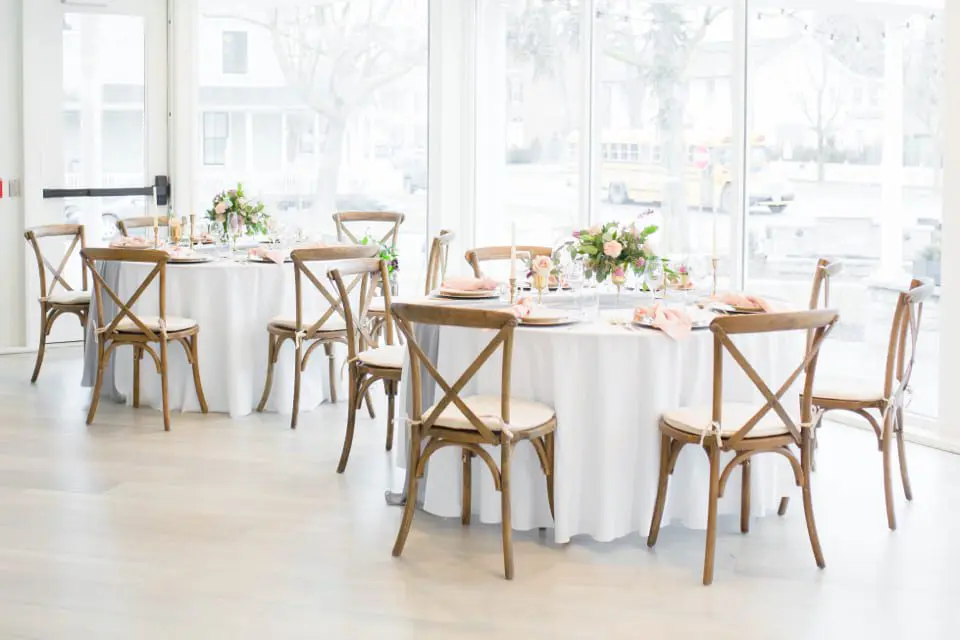 Wedding reception tables beside the large windows