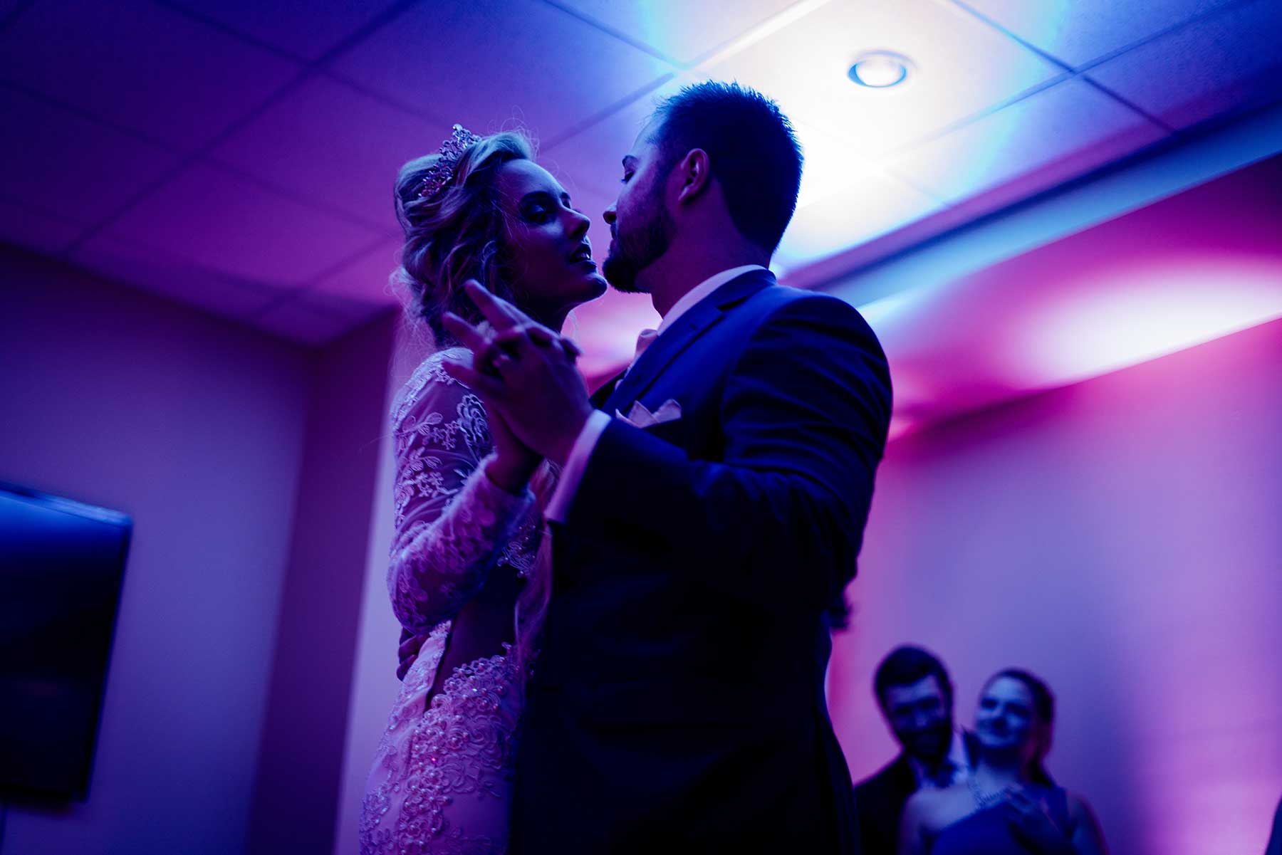 Newlyweds sharing their first dance under warm wedding lighting in Niagara