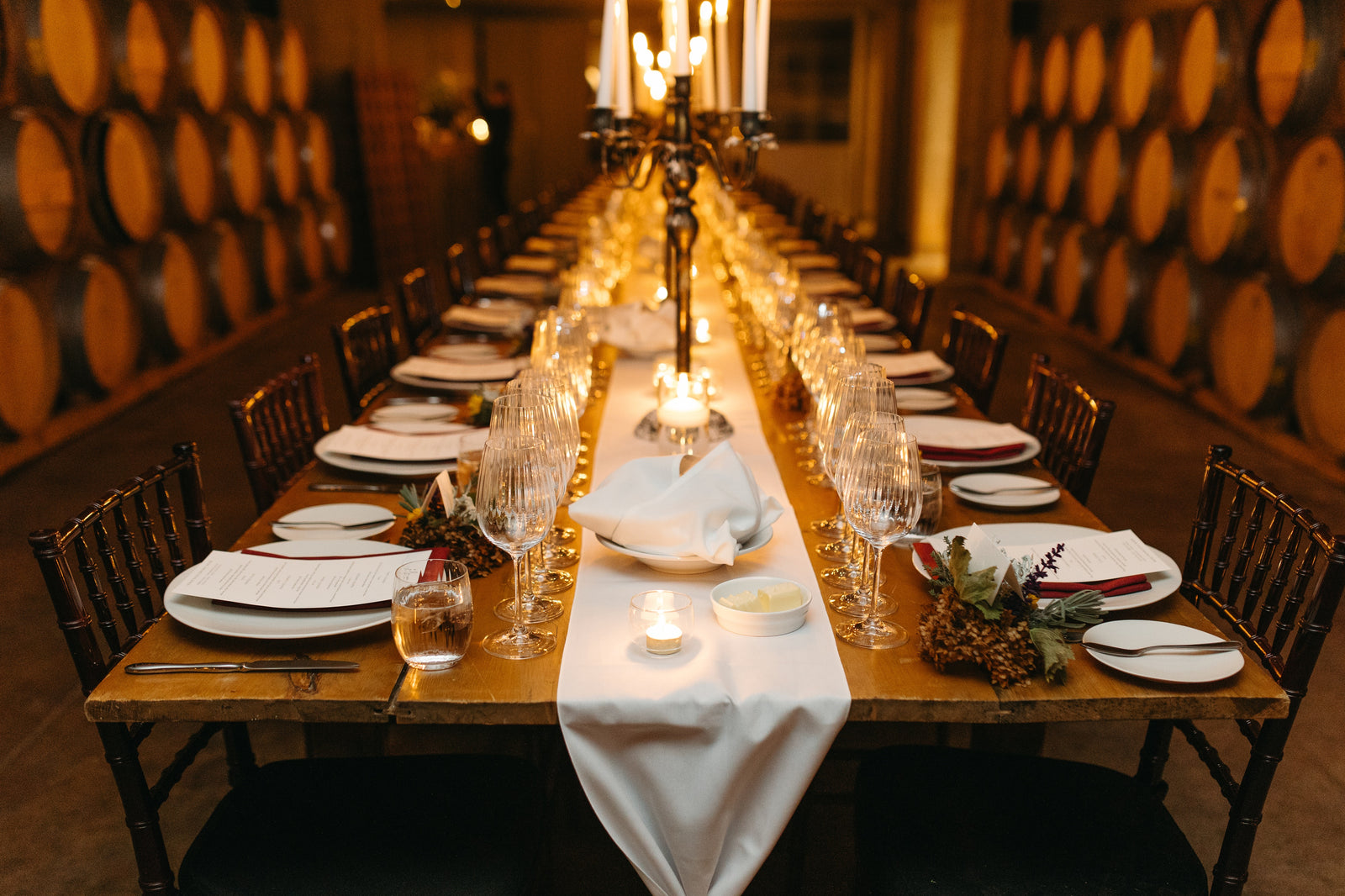 Long-table wedding dinner in the Ravine Vineyard Barrel Cellar