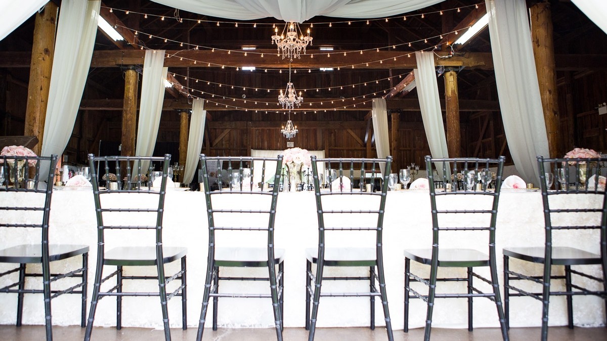 Reception tables and lighting inside the Big Barn at Ball’s Falls
